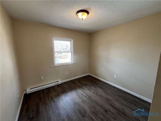 unfurnished room featuring dark hardwood / wood-style flooring, a textured ceiling, and a baseboard heating unit