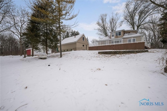 yard covered in snow with covered porch