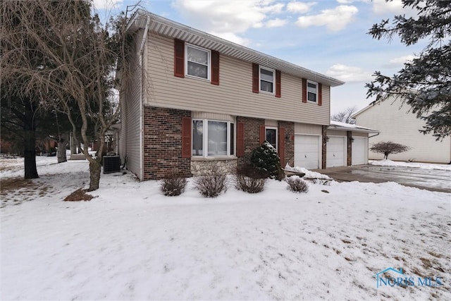 view of front of home featuring central AC and a garage