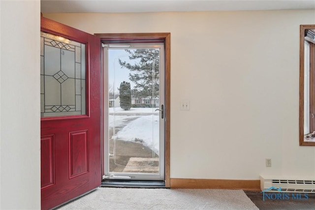 entrance foyer with carpet and a baseboard heating unit