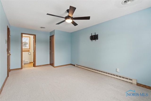 carpeted empty room featuring a baseboard heating unit and ceiling fan