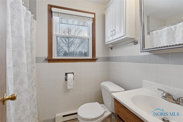 bathroom with toilet, a baseboard heating unit, tile walls, and vanity