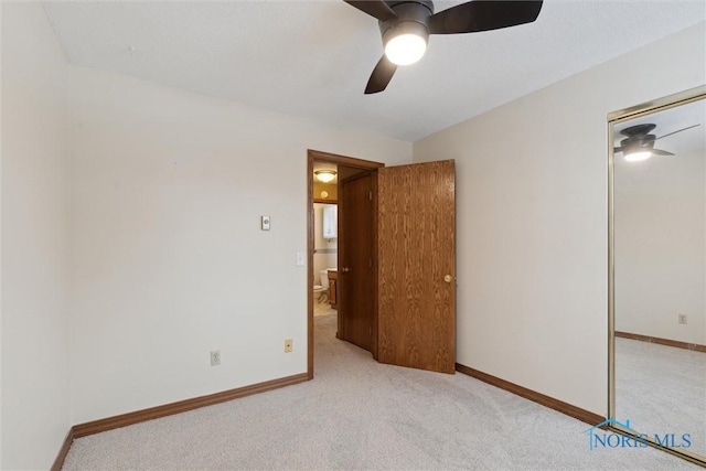 empty room featuring light carpet and ceiling fan