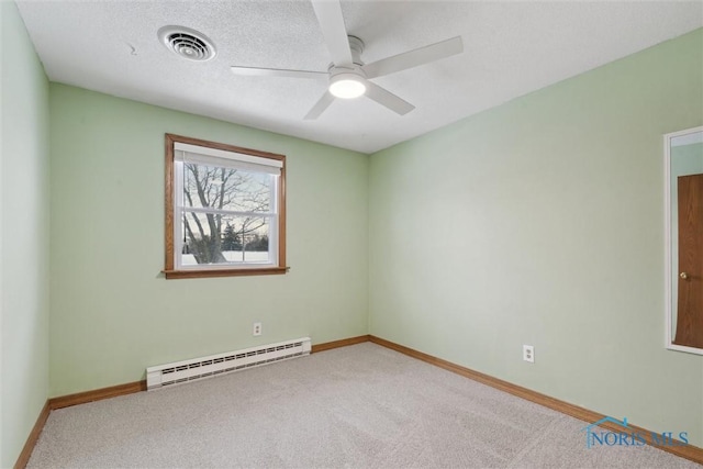 spare room with baseboard heating, ceiling fan, carpet floors, and a textured ceiling