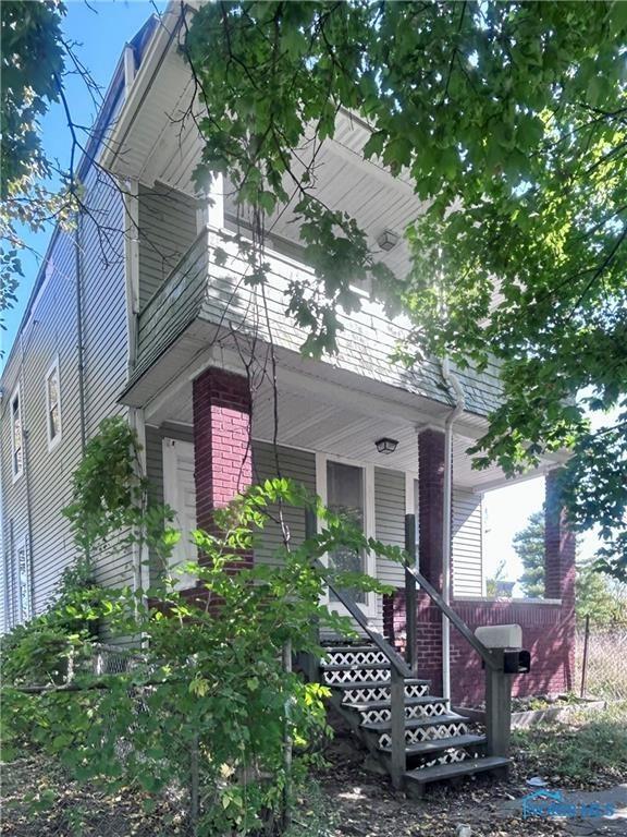 view of side of home with covered porch