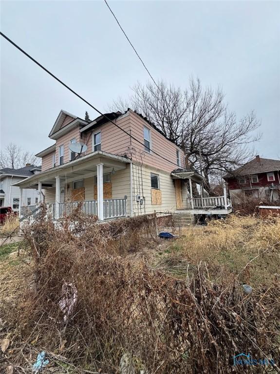 view of property exterior featuring covered porch