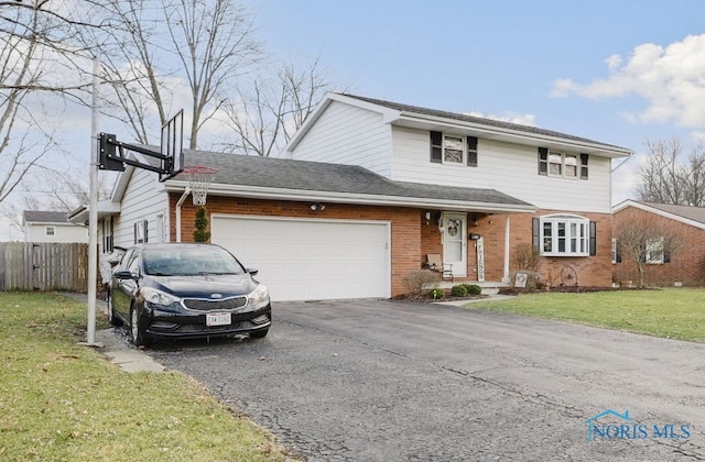 view of property featuring a garage and a front lawn