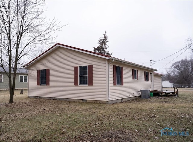 view of home's exterior featuring a lawn and central air condition unit