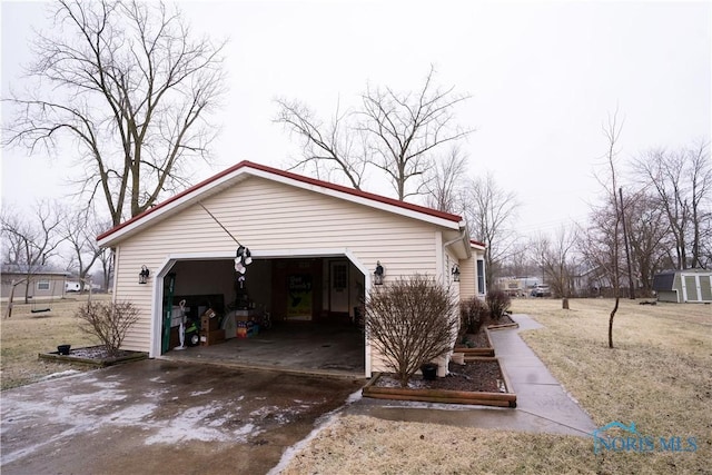 view of side of home with a garage and a lawn