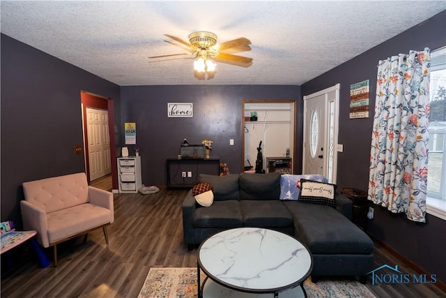 living room featuring ceiling fan, a healthy amount of sunlight, hardwood / wood-style floors, and a textured ceiling