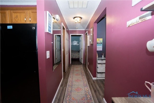 hallway featuring dark hardwood / wood-style flooring and crown molding