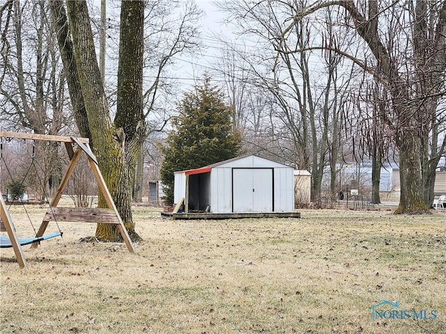 view of outbuilding featuring a playground and a lawn