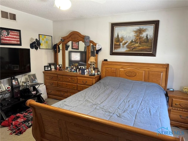 carpeted bedroom featuring a textured ceiling