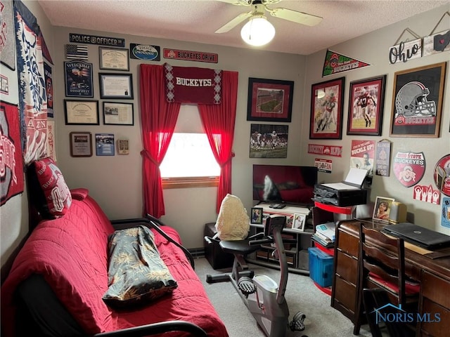 bedroom with ceiling fan, light colored carpet, and a textured ceiling