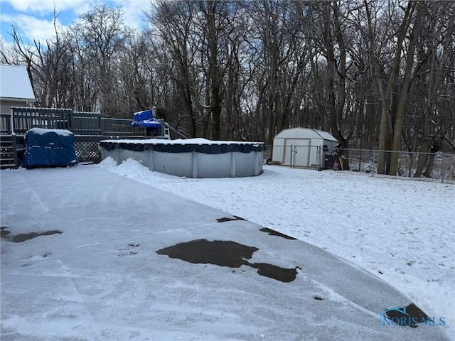 yard covered in snow featuring a covered pool