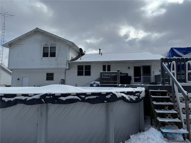 back of property with a wooden deck