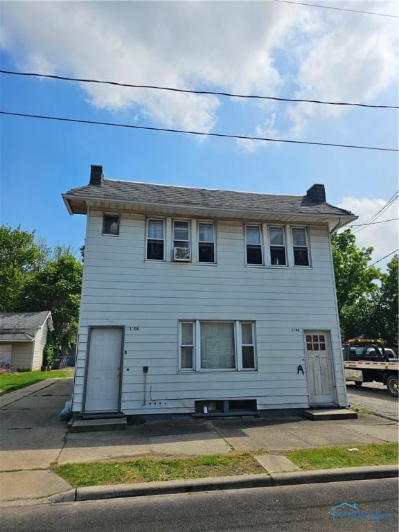 view of front facade featuring a chimney