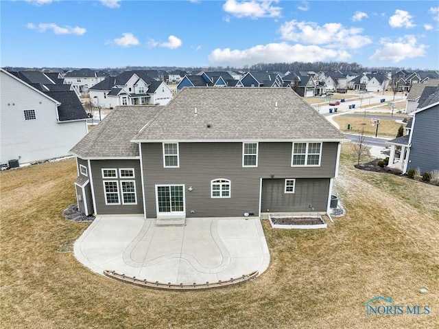 back of property featuring a patio, cooling unit, and a lawn