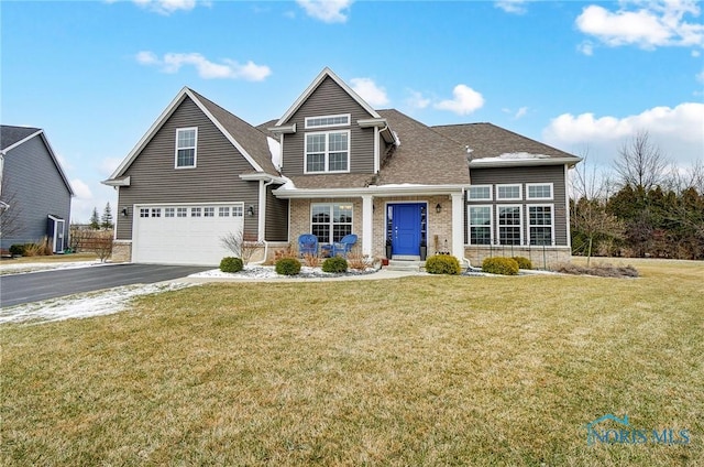 view of front of home featuring a garage and a front yard