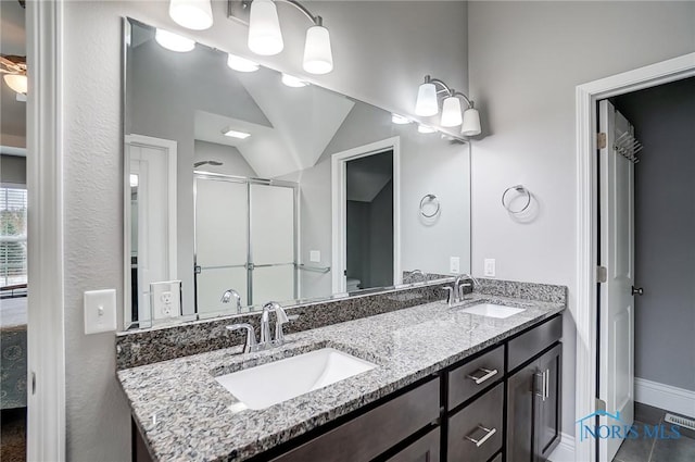 bathroom featuring vanity, toilet, and walk in shower