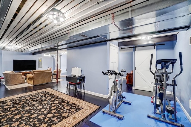 exercise room featuring a barn door