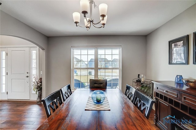 dining area featuring dark hardwood / wood-style floors and a notable chandelier