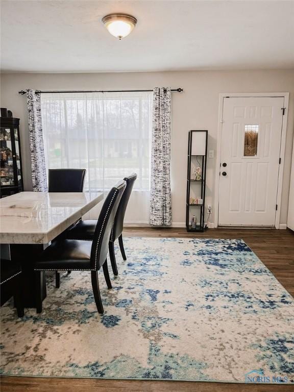 dining area with dark wood-type flooring