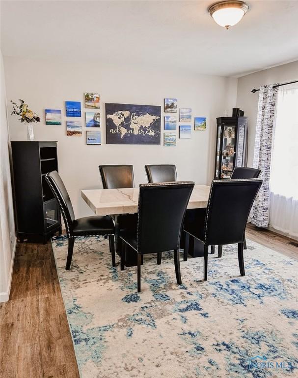 dining room with hardwood / wood-style flooring