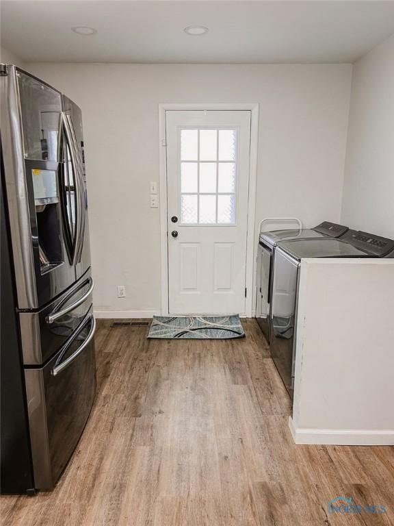 washroom featuring independent washer and dryer and light wood-type flooring