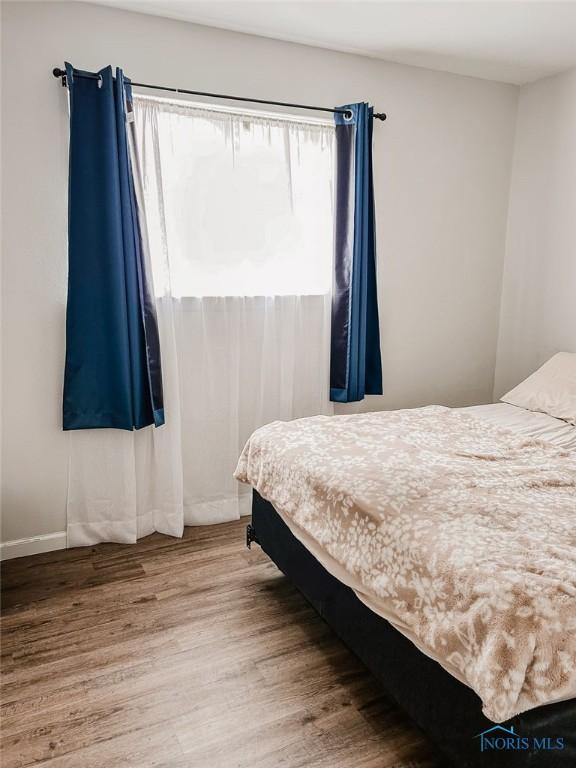 bedroom with hardwood / wood-style flooring