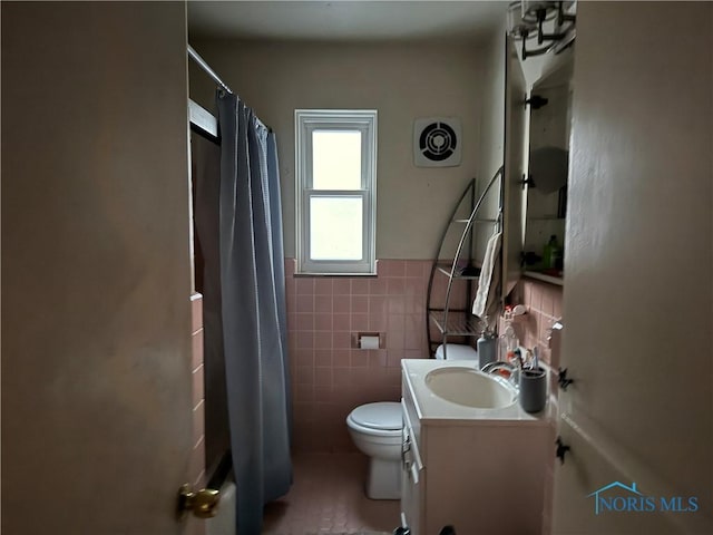 full bathroom with tile walls, vanity, shower / bath combo, and toilet