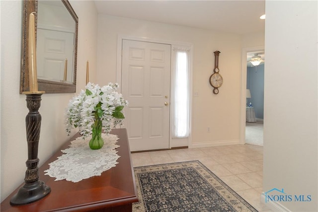 foyer entrance featuring baseboards and light tile patterned flooring