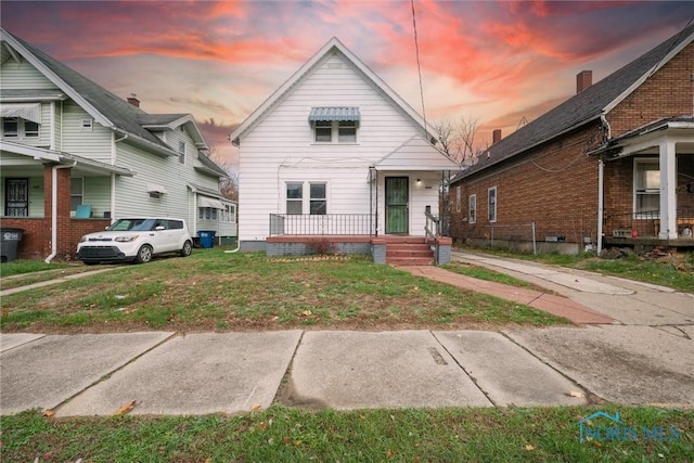 bungalow-style house featuring a lawn