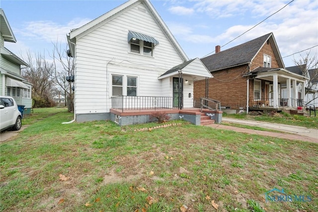 view of front of home featuring covered porch and a front yard