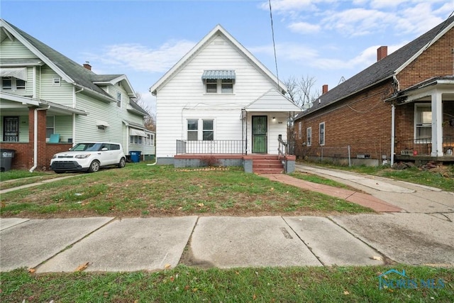 bungalow-style home with a front lawn