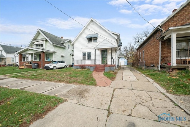 bungalow-style home featuring a front yard