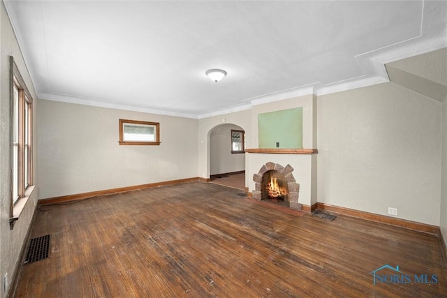 unfurnished living room featuring crown molding, dark hardwood / wood-style floors, and a fireplace