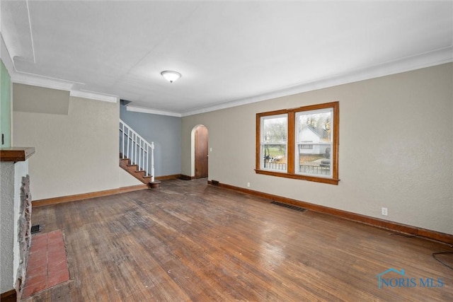 unfurnished living room featuring dark hardwood / wood-style flooring and crown molding