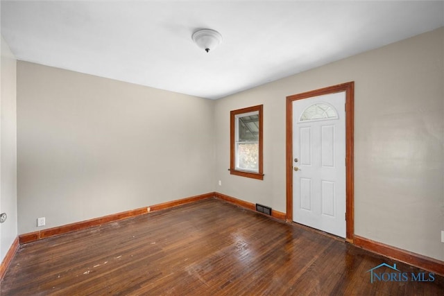 entryway with dark hardwood / wood-style flooring