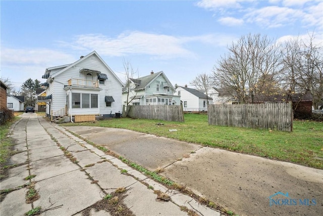 rear view of property featuring a yard