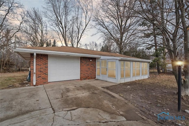 garage at dusk with driveway