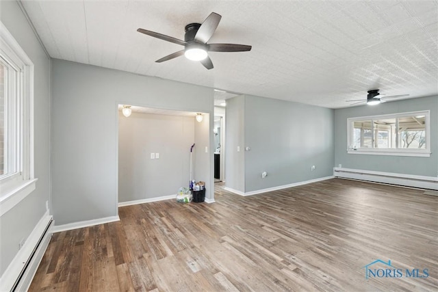 interior space with baseboards, a ceiling fan, a baseboard radiator, wood finished floors, and baseboard heating