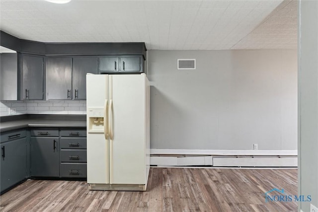 kitchen with white fridge with ice dispenser, visible vents, wood finished floors, and gray cabinetry