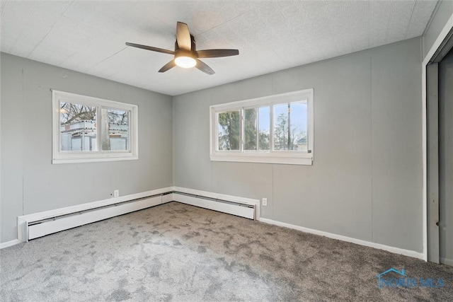 spare room featuring carpet floors, ceiling fan, and baseboard heating