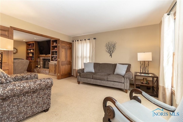 carpeted living room with a fireplace