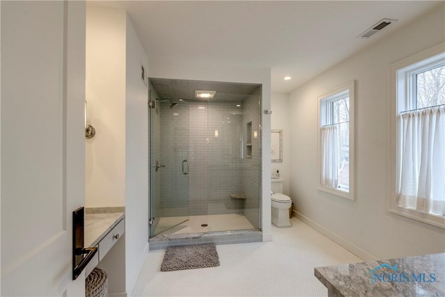 bathroom featuring vanity, toilet, and an enclosed shower