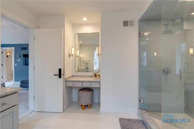 bathroom with walk in shower and vanity