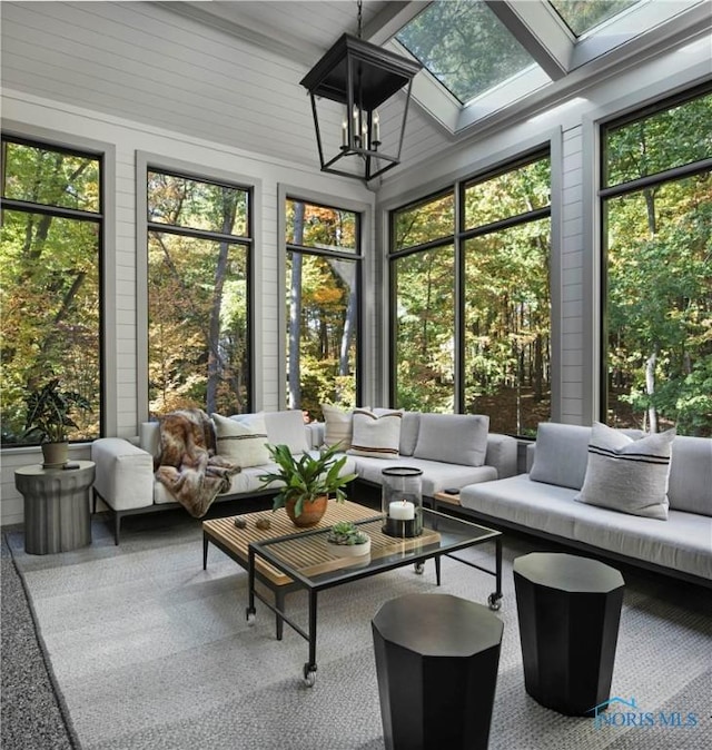 sunroom featuring an inviting chandelier