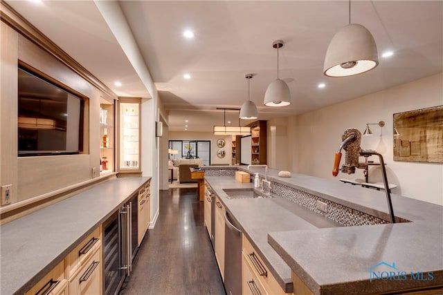 kitchen with dark hardwood / wood-style flooring, sink, decorative light fixtures, and dishwasher