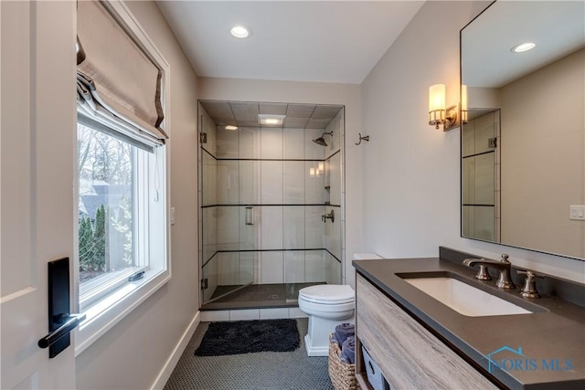 bathroom with vanity, an enclosed shower, and toilet